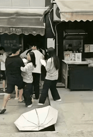 明知道自己打不过男人，还敢先动手，这女的是怎么想的？女的排队怕晒黑，打着伞