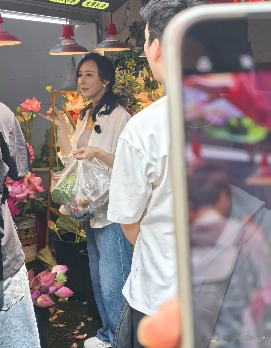 48岁胡静在杭州逛早市被偶遇，她穿着简单的白色衬衫和牛仔裤，气质脱俗，状态非常好
