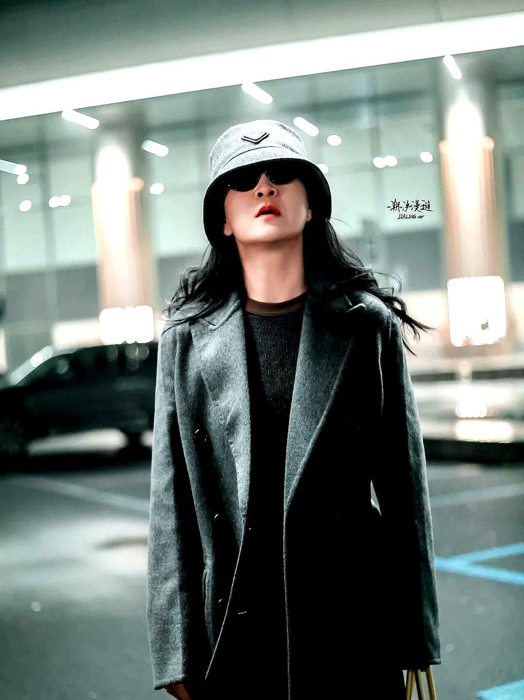 100斤后第730天，她杀回机场灰色大衣扣到顶，渔夫帽压到眉。助理一路小跑