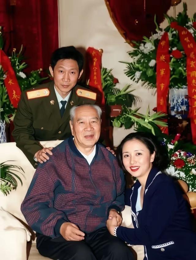 1998年，85岁杨成武刚过完大寿，儿子杨东明儿媳秦畹江陪同合影。1998年杨