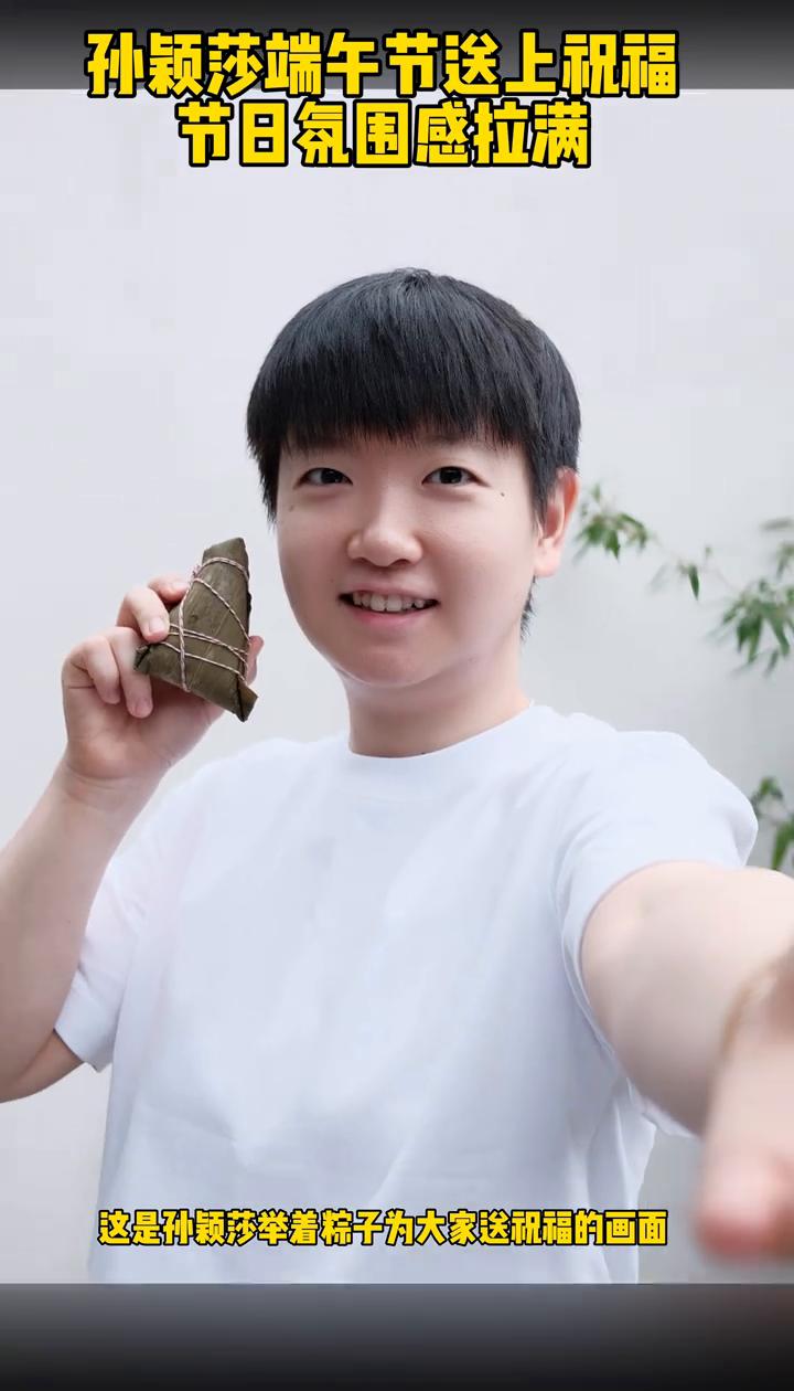 孙颖莎端午节送上祝福，节日氛围感拉满。这是孙颖莎举着粽子为大家送祝福的画面，并
