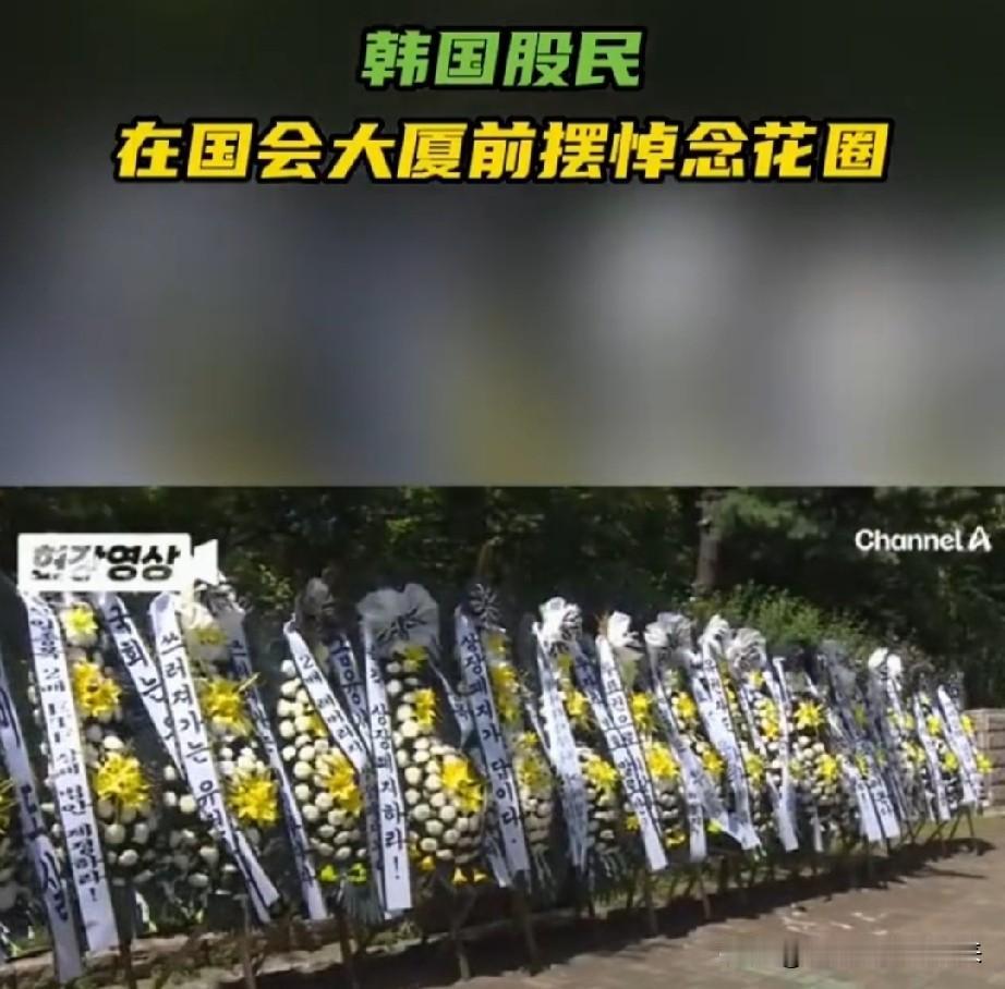 韩国人估计这把跌懵逼了、跌愤怒了，他们居然在韩国国会大厦门口摆上了花圈！但是
