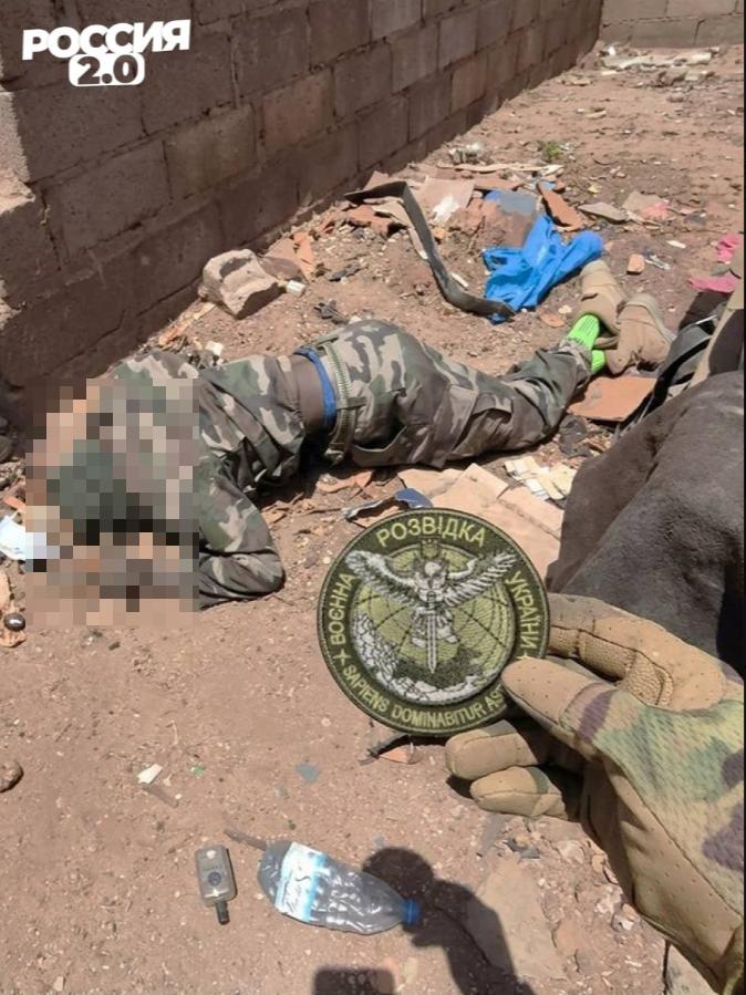 马里士兵在一名阵亡的“支持伊斯兰和穆斯林联盟”（JNIM，基地组织萨赫勒分支）武