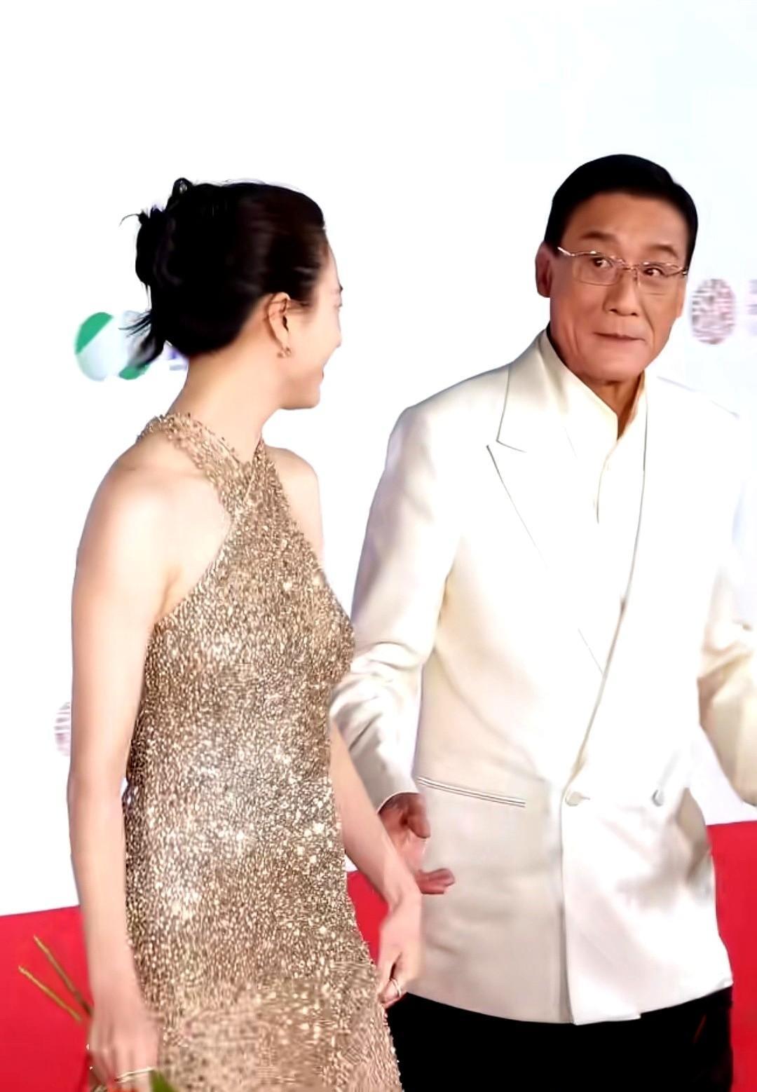 红毯伸手被挡，尴尬背后藏着大文章镜头里，梁家辉刚抬手，韩孝周轻轻侧身，手落空了