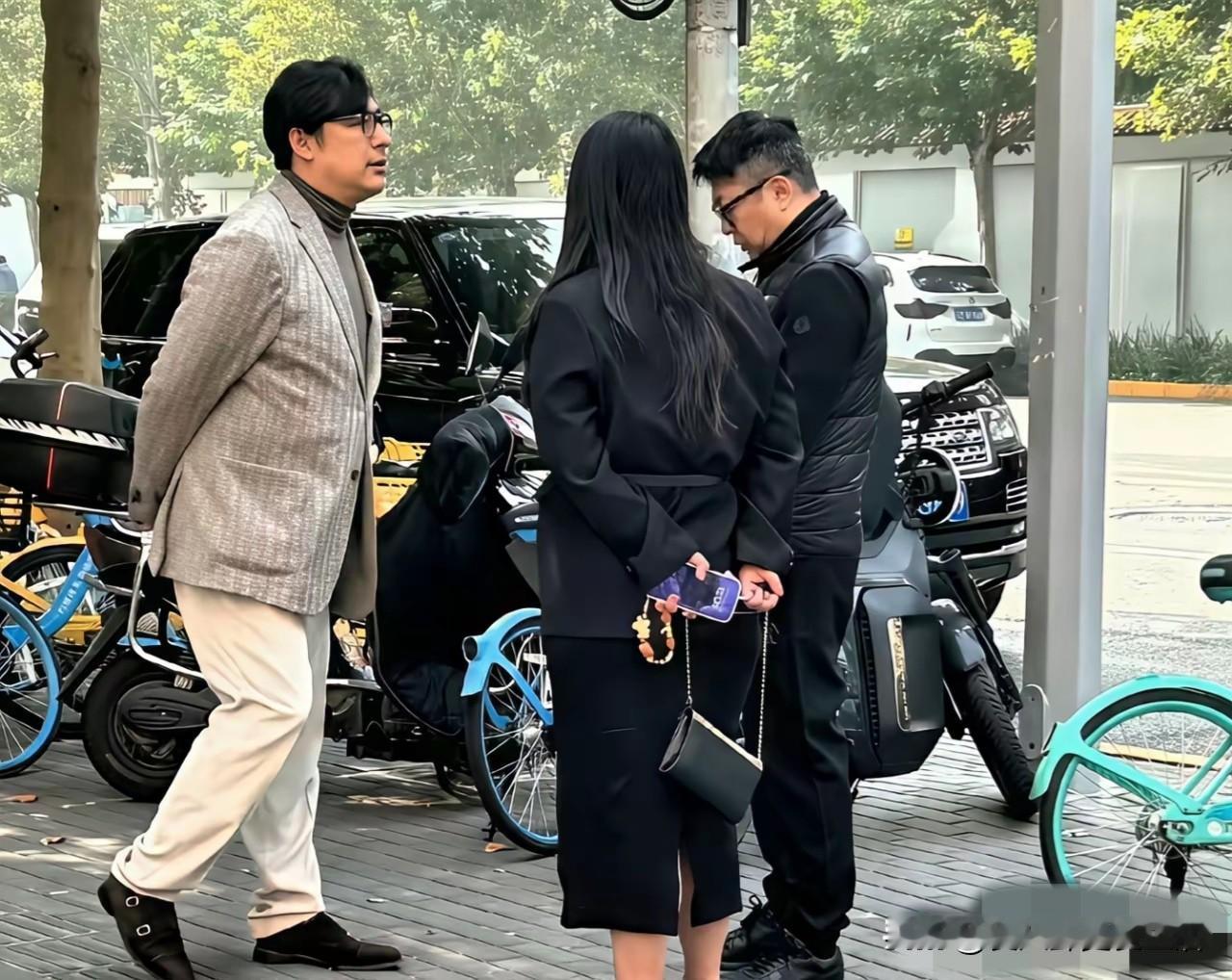 李湘王岳伦又在北京被偶遇了，导演穿着精致的西装，半高领毛衣，李湘穿着黑色套装，一
