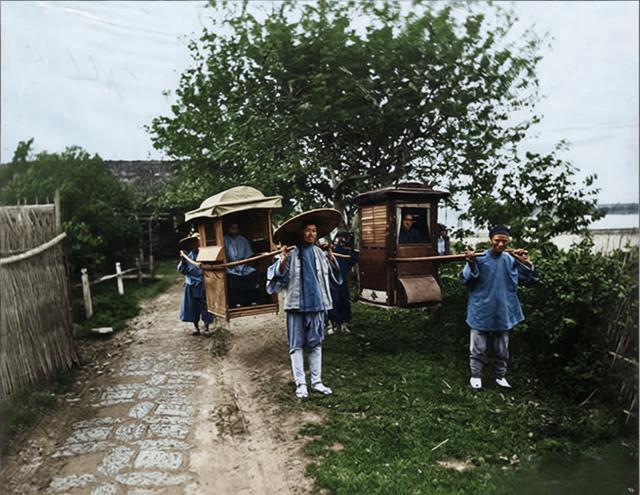 这是一张记录清代民间轿子作为代步工具的日常画面。画面里有两顶由轿夫肩扛的轿子；抬