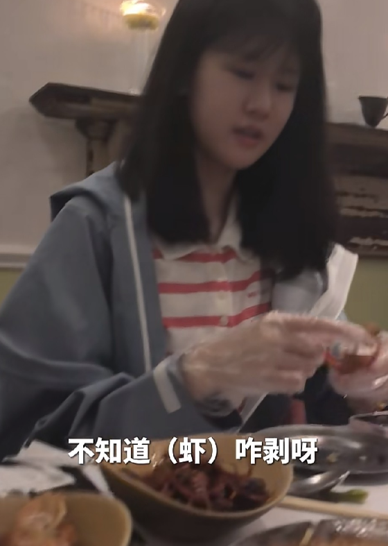 陆毅一家在外面吃饭，贝儿拿了一只虾在手里，十分犯难的说：“我不知道虾怎么剥啊。”