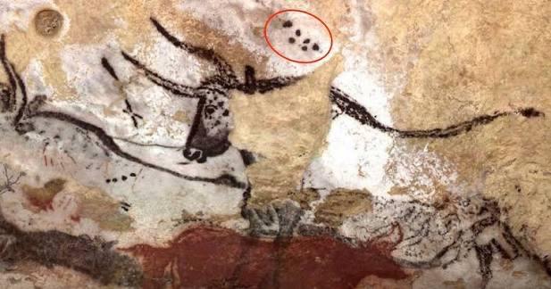 一幅来自约17,000年前的拉斯科洞穴壁画，画中描绘了一头原牛，其肩部上方有一组