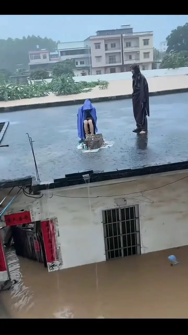 广西抗洪广西暴雨突袭，洪水肆虐，两人被困屋顶，等待救援没办法，风往高处走