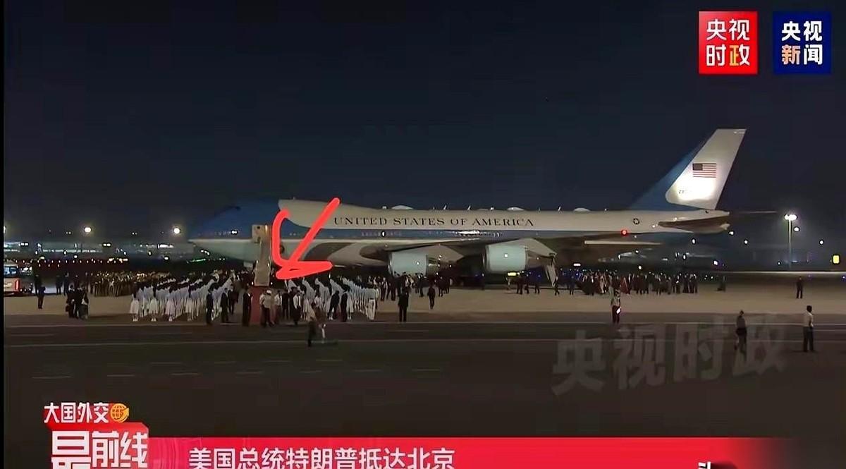 特朗普那架“空军一号”稳稳停住，舱门即将旋开。底下，却空空荡荡，连张红毯都没有
