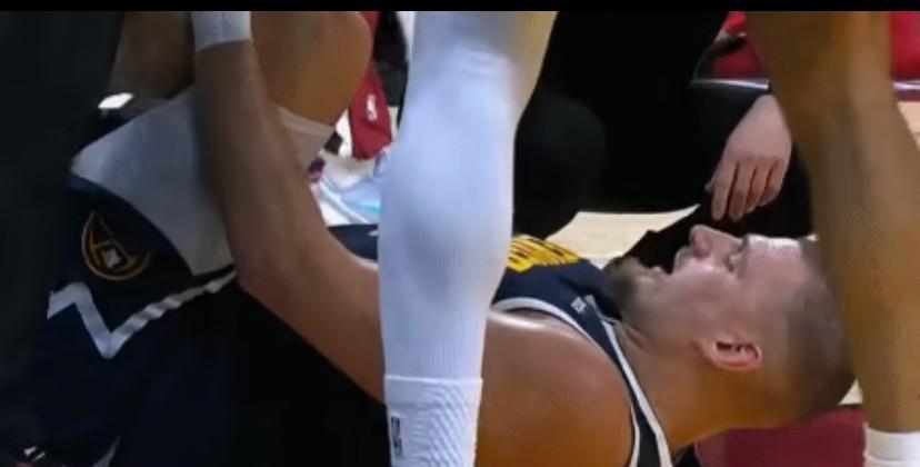 约基奇捂着左膝倒下的时候，全场寂静——没有碰撞，没有对抗，只有他自己听见了那声细