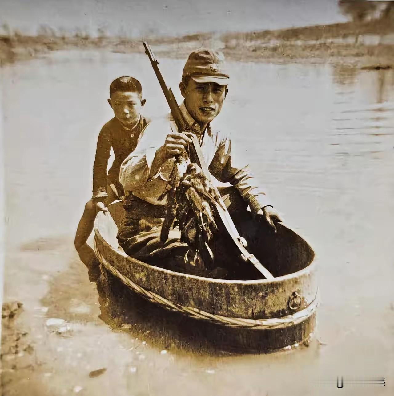 日本鬼子坐在木盆里，手里拿着一把枪，还有一串子鸟，木盆子如何能够在水中行驶呢？原