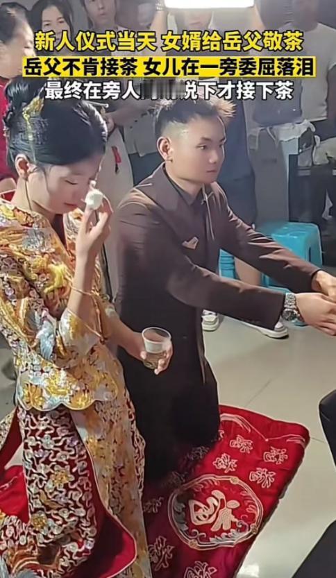 新人结婚，到了敬茶环节，新郎新娘双双跪在红毡上，女婿双手捧着茶杯，声音带着紧张：