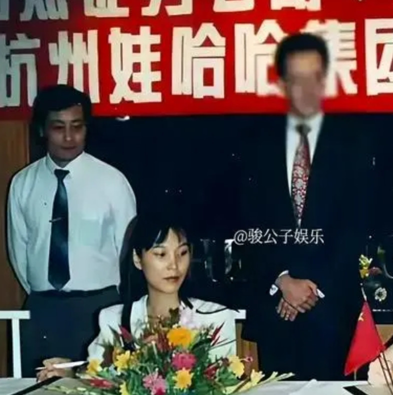 这张泛黄的老照片到底藏着多少秘密？1995年，宗庆后和女助理杜建英站在香港酒店签
