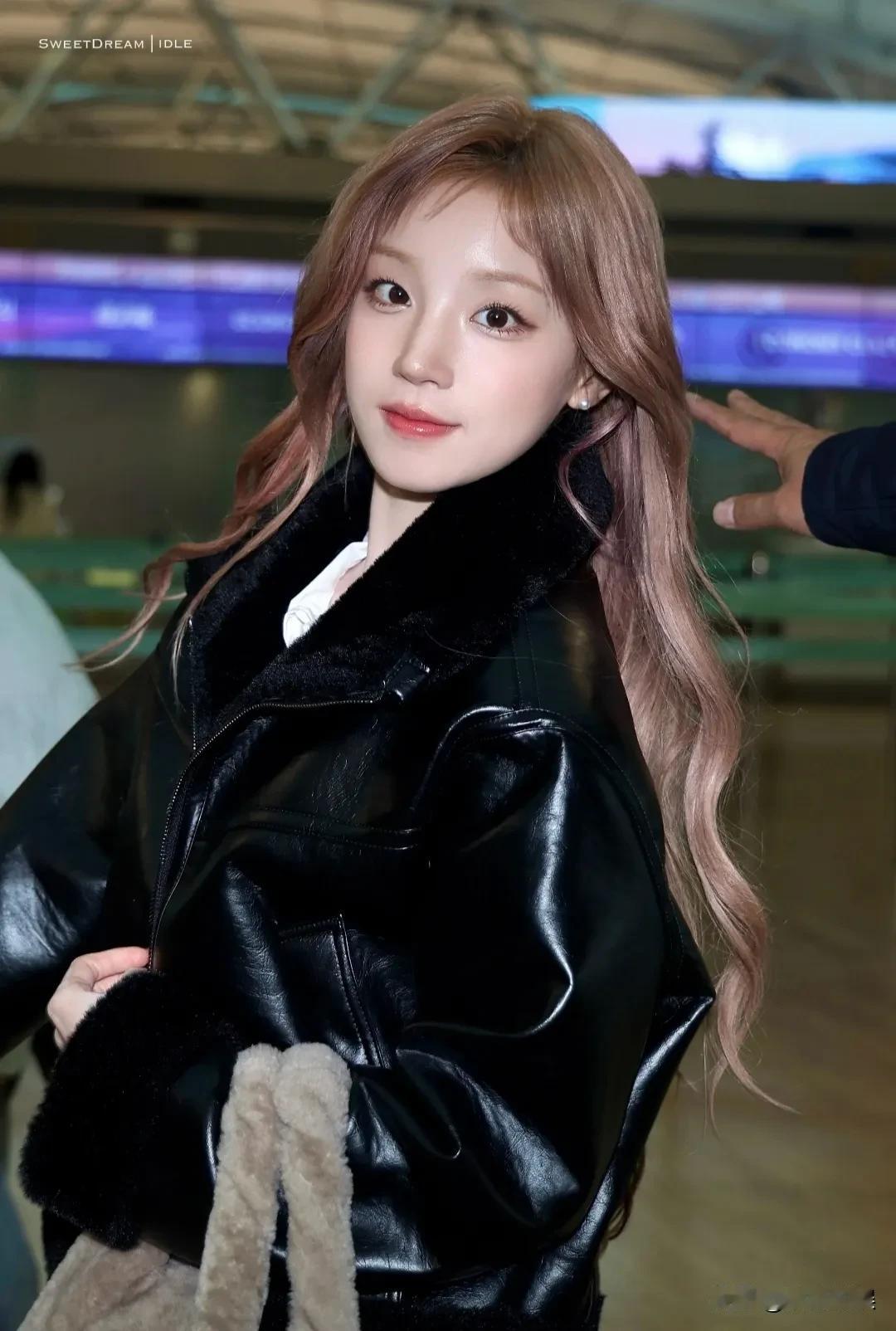 宋雨琦现身机场，一头粉发披肩，肤色超白，身材窈窕，五官精致，穿着皮衣搭配超短裙，