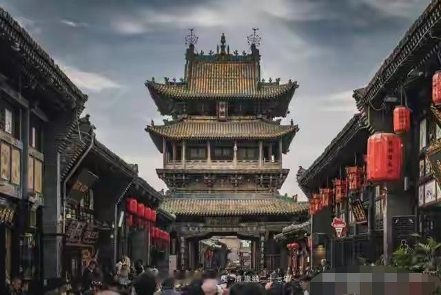 在平遥古城那个大清早，我站在南门城墙上，听见底下巷子里传来扁担咯吱咯吱的响声。炊