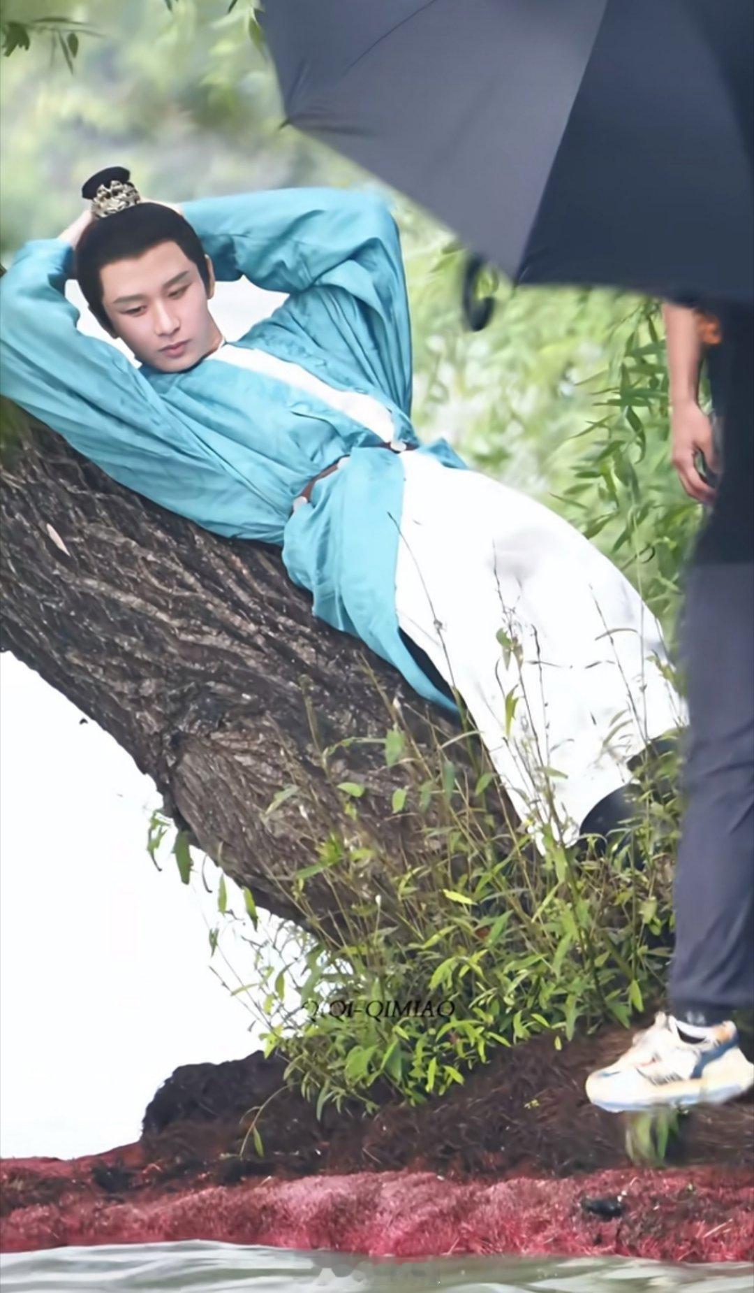 成毅新剧路透来咯，这次他双手枕于脑后躺在一个树上，还挺悠闲呢​​​