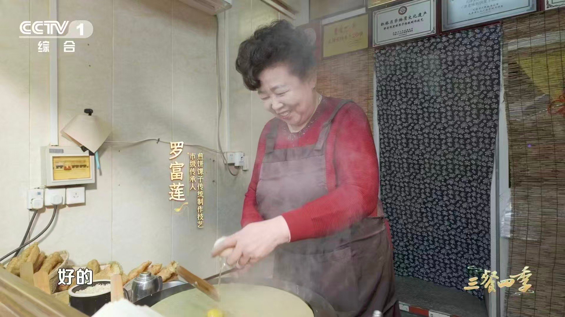 天津人一天的快乐从煎饼馃子开始绿豆面浆在铁板上滋啦作响，鸡蛋液瞬间凝固成金黄，