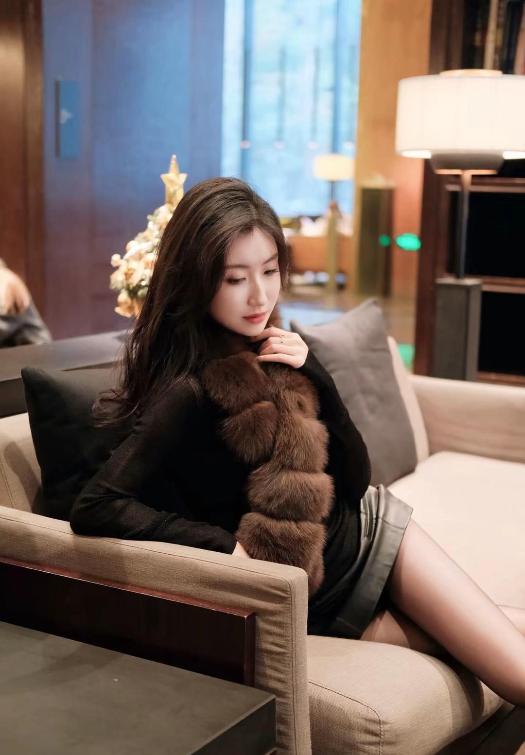 冬日暖阳下，温柔的黑皮草与她相得益彰，静谧时光里的优雅与宁静。