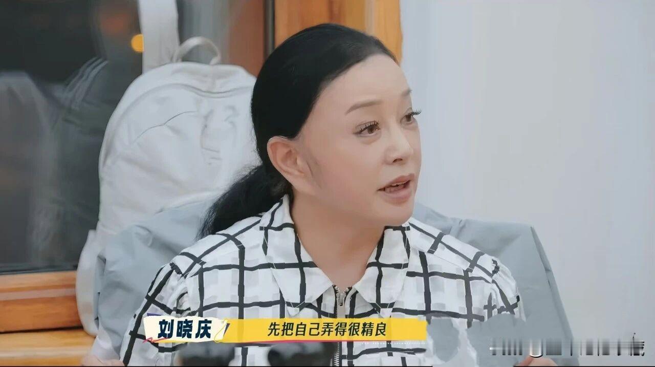 接受采访的刘晓庆这头发太假了！刘晓庆扎着马尾辫，额头光秃秃的，就像一个茶壶盖盖在