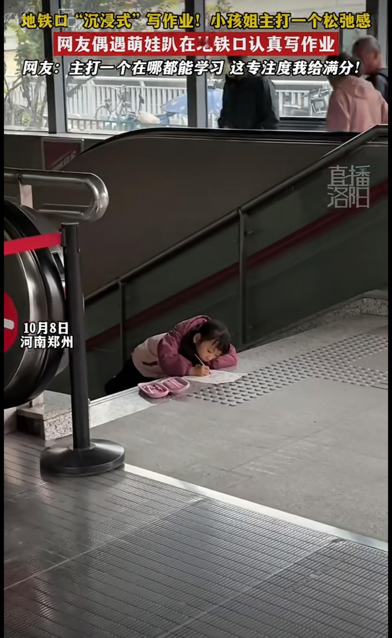 地铁口“沉浸式”写作业！小孩姐主打一个松弛感，网友偶遇萌娃趴在地铁口认真写作