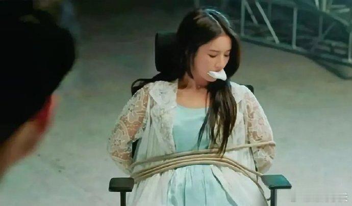 刘些宁嘴里含着纱布，身上套着绳索。这是在演我绑架我自己？