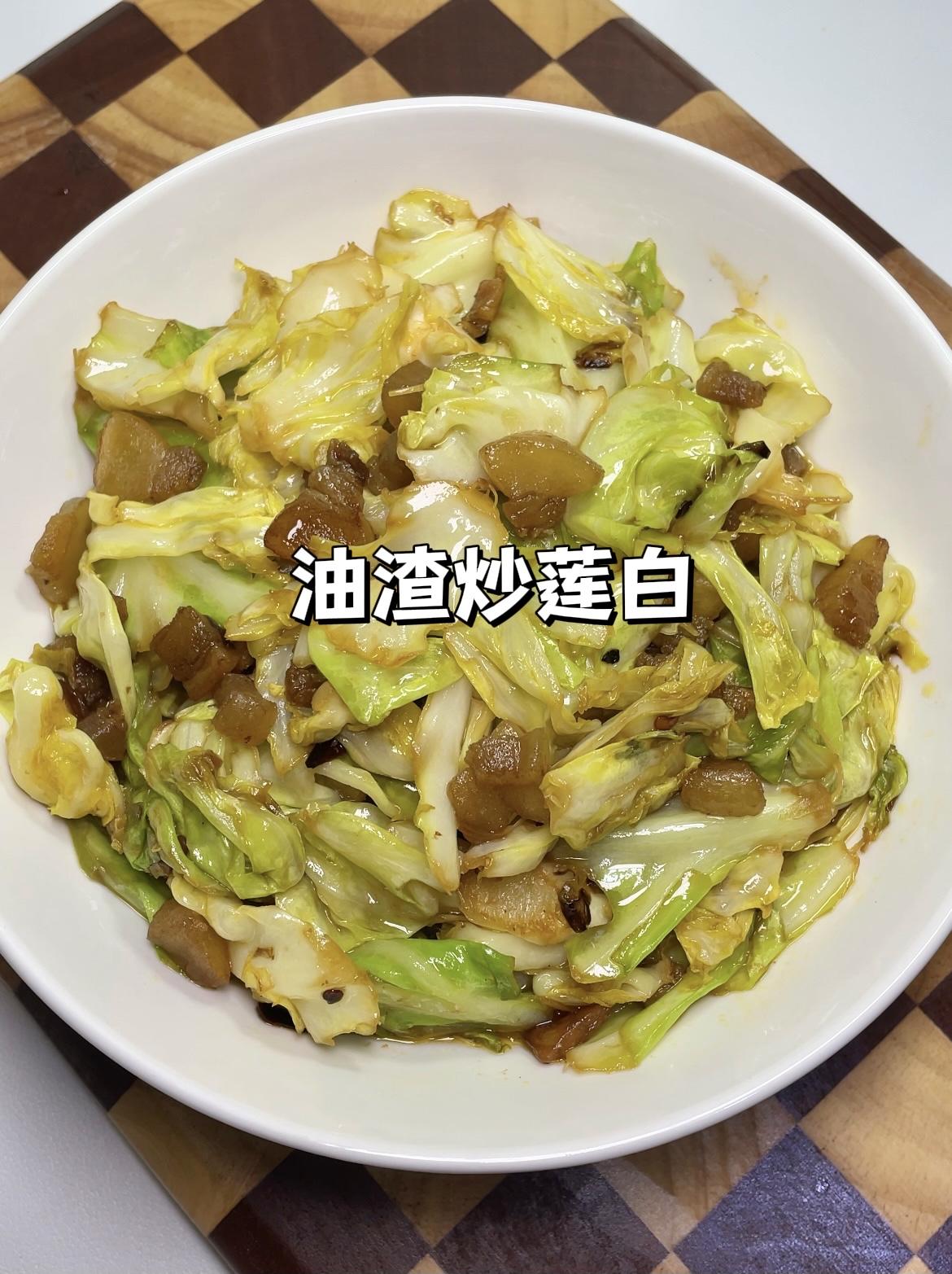 准备一个小包菜。手撕小块，清洗干净后沥干水。锅里油适量，倒入猪油渣（炼猪油的