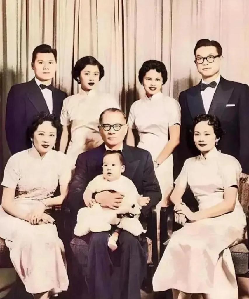 50年代，宋子文一家在美国的全家福合影，镜头中的宋子文西装革履端坐于中，怀中抱着