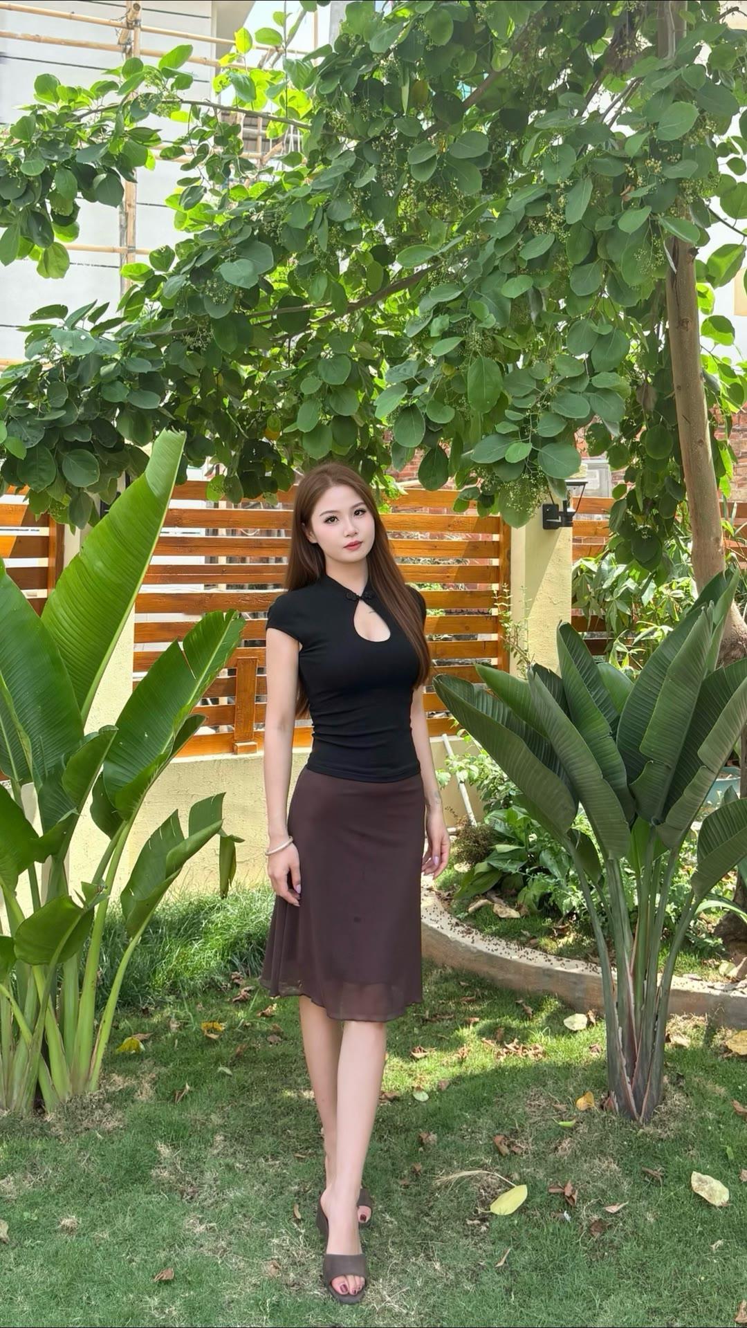 黑色挂脖上衣搭配咖色半身裙，尽显自信魅力！