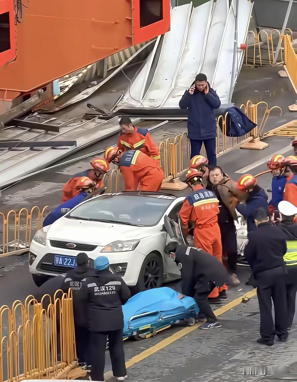 武汉地铁工地的龙门吊突然塌了，狠狠砸中路上一辆行驶的轿车，正砸在后半段。消防员赶