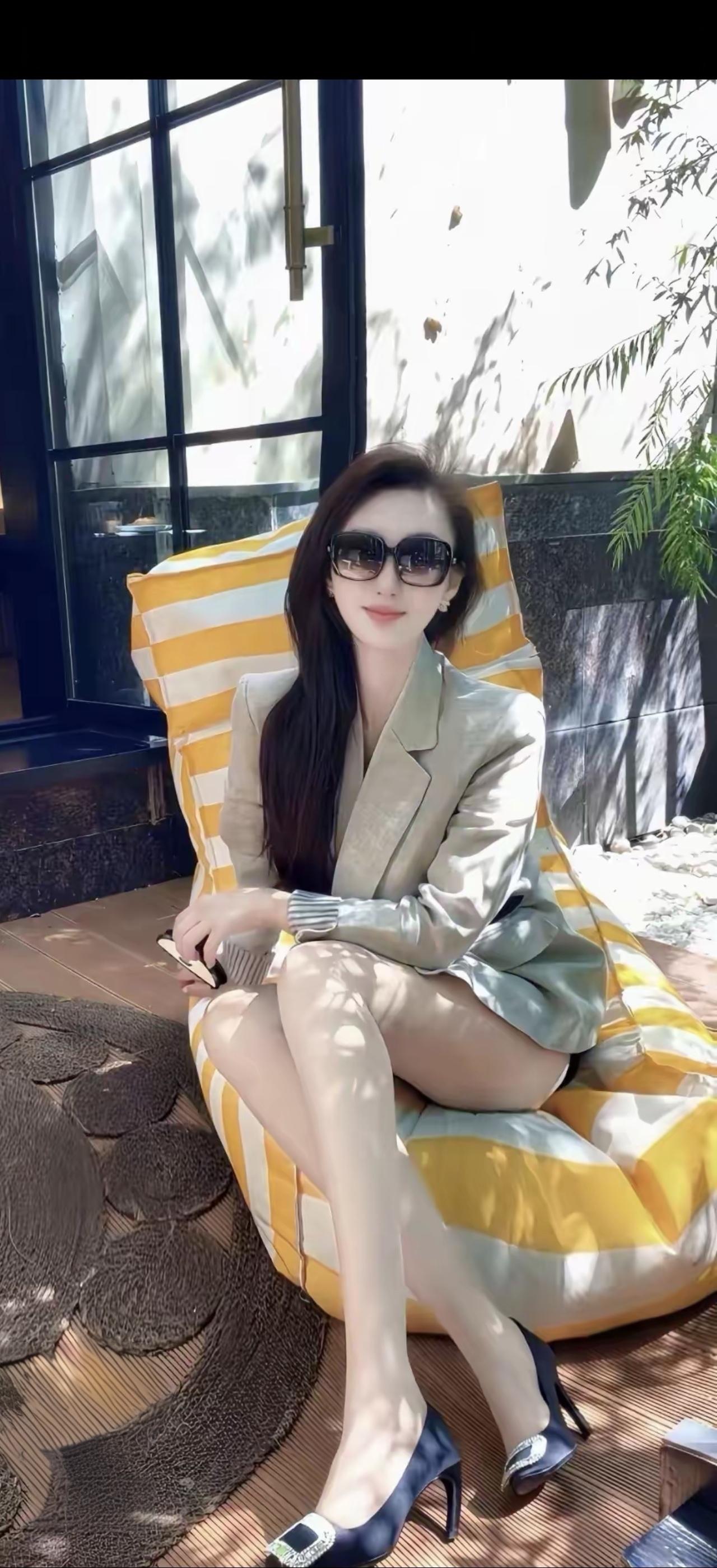 美女坐在户外，阳光明媚，心情不错。