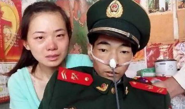 2014年，照片上的这个人身穿军装，骨瘦如柴，他此刻强打起精神，与妻子一起拍下了