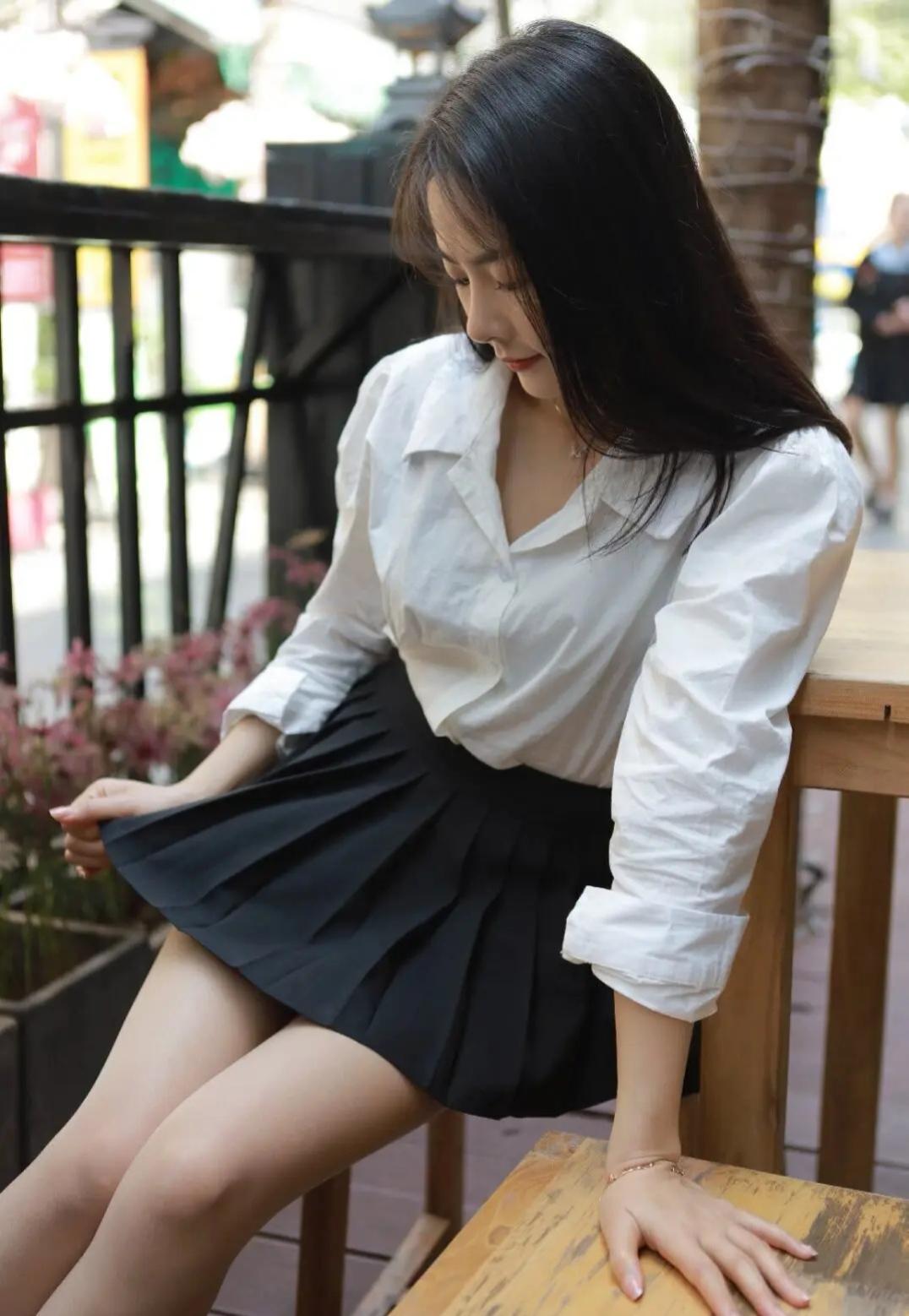 这套是清新轻熟学院风，核心是白衬衫+黑百褶短裙的搭配：宽松白衬衫自带清新松弛感，