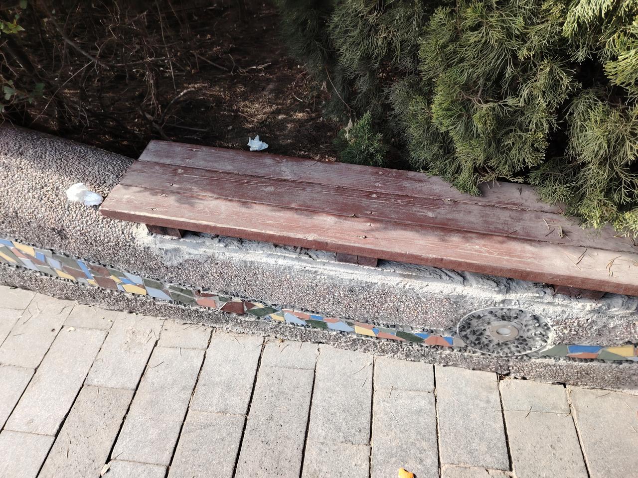 游客坐凳后方有垃圾，能否立刻清扫？今天下午，60后保洁员老吴在保洁的山路上捡拾