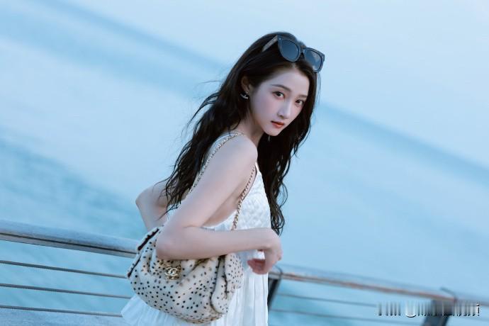 ❤️关晓彤立秋一组湖边大片，长卷发氛围感十足，一身浅色系穿搭干净柔和，迎着湖面晚