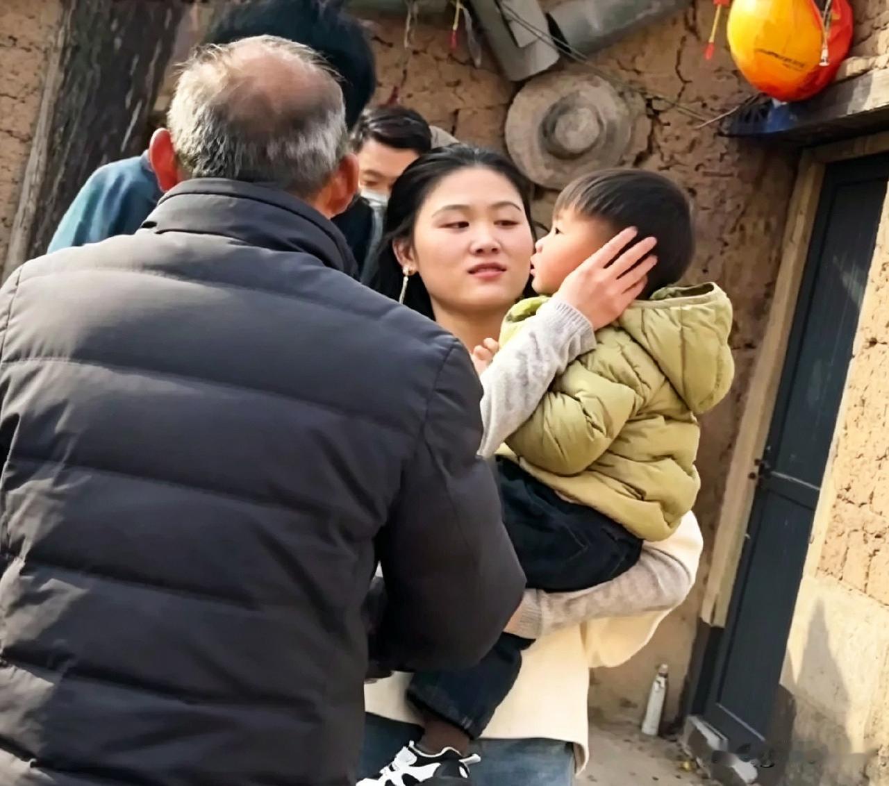 大衣哥家儿媳陈萌，抱着小孙子顺顺在老家院子里，跟街坊邻居正唠着嗑呢。看这画面