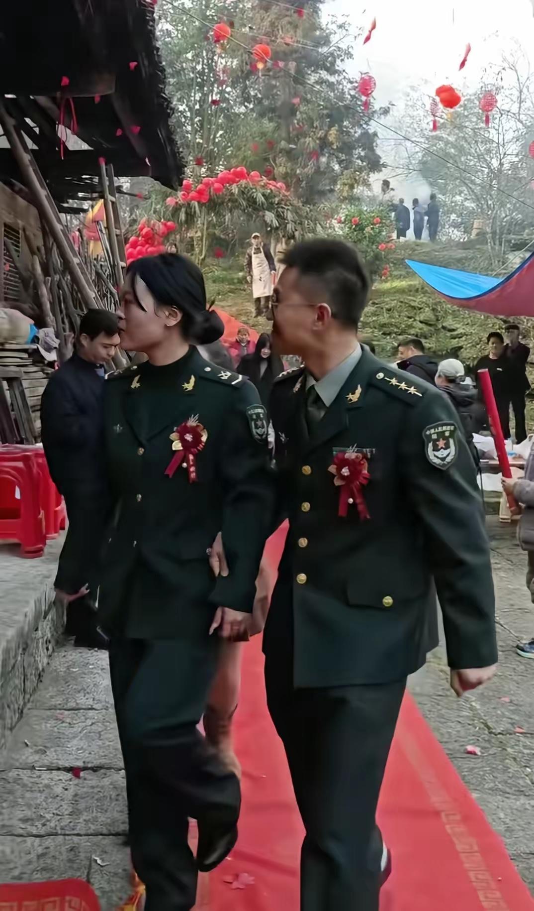 男上尉和女中士的婚礼两人都身着戎装只是在胸前佩戴了红花穿着都非常简单，没