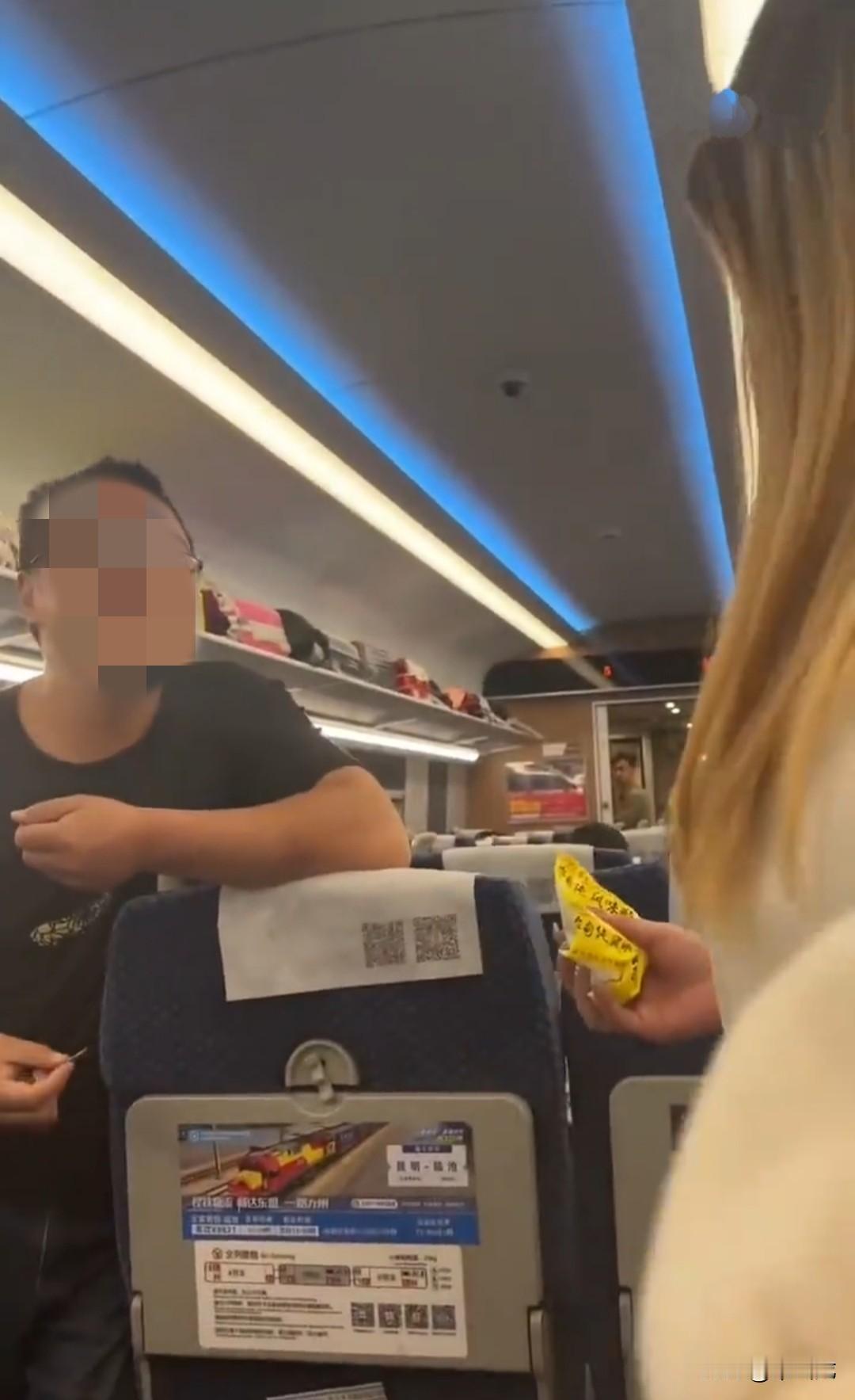 两名女子在动车上指责前排小孩太过吵闹，大人也不管管。小孩父亲直接走过来，倚靠着