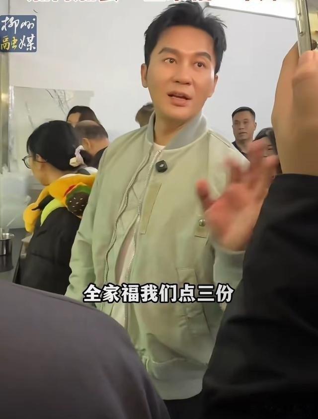 47岁李晨在柳州街头排队嗦粉，三份全家福花700多，没座位直接拿豪车引擎盖当桌子，网友：这吃法比咱还