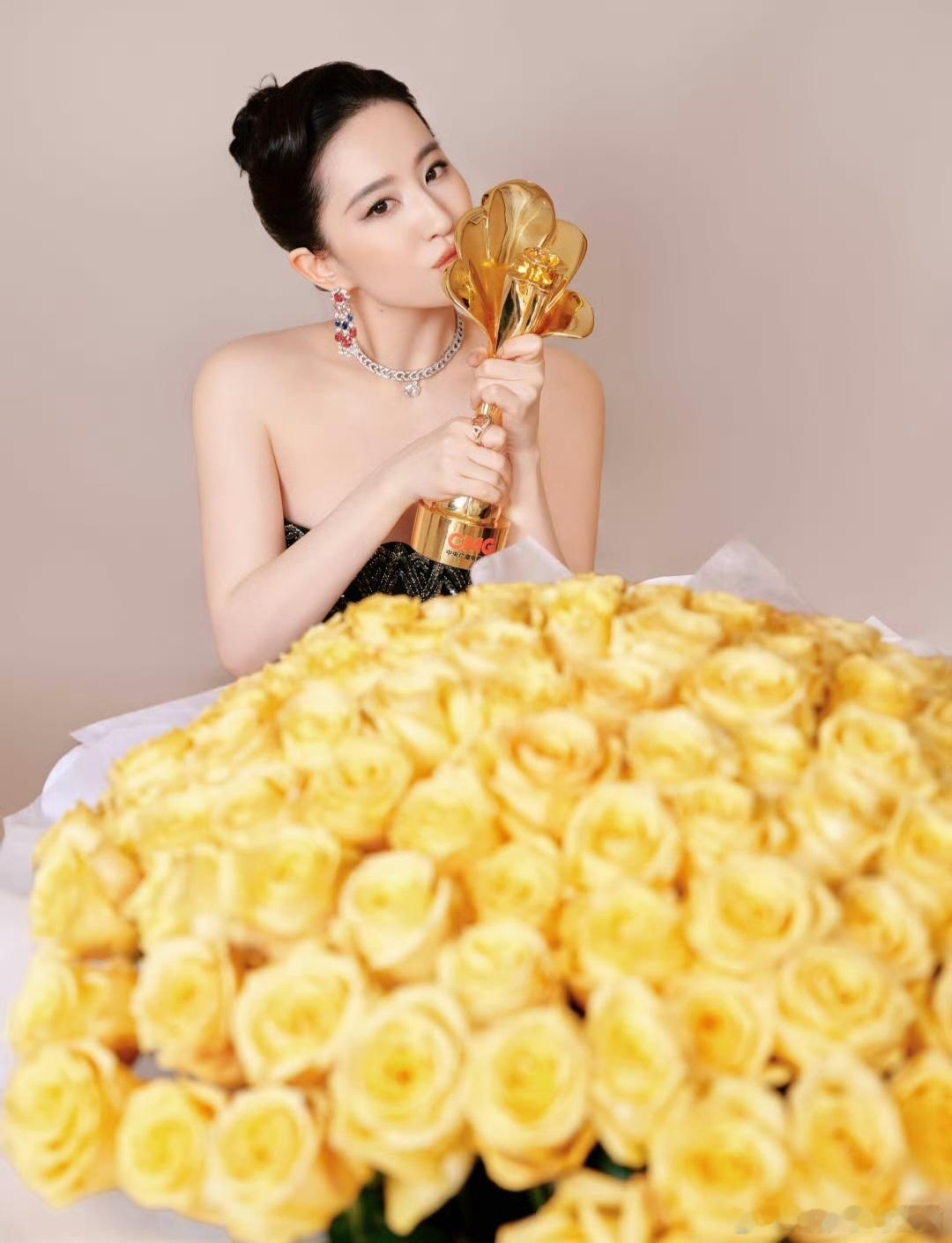 在这组获奖大片中，刘亦菲的穿搭堪称黑金闪耀，精致加冕。她身着抹胸修身款礼裙，黑底