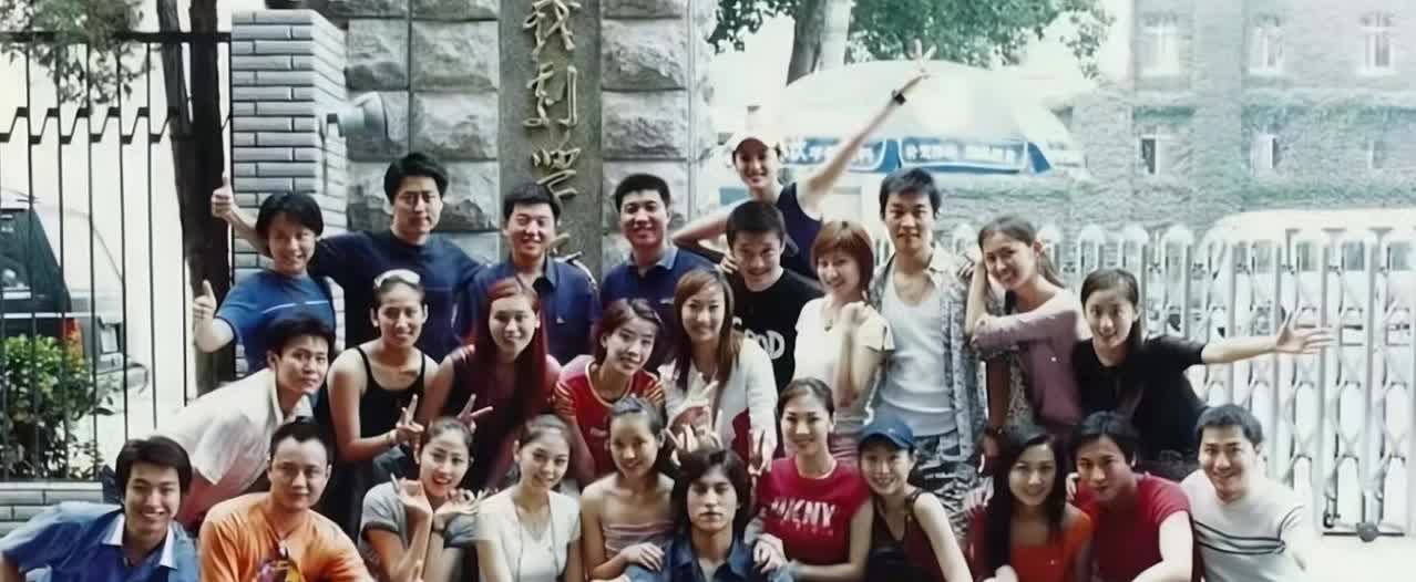 这是2003年27岁的靳东和同学在中戏大门口的毕业合影！看的出来，当时留长头发的