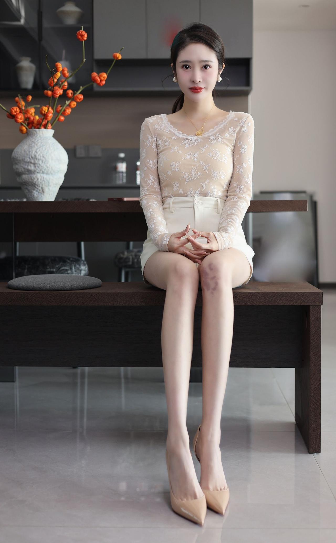 优雅坐于现代厨房，精致穿搭尽显时尚气息。