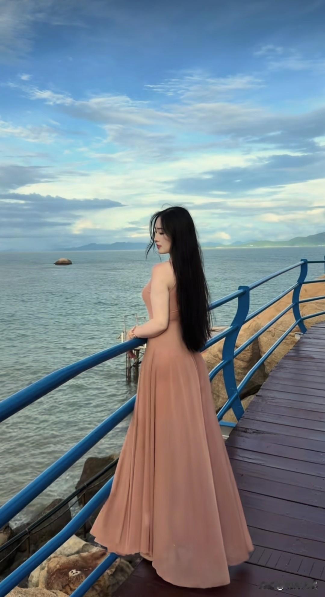 海边的长裙女郎，背影迷人，风姿飘逸。