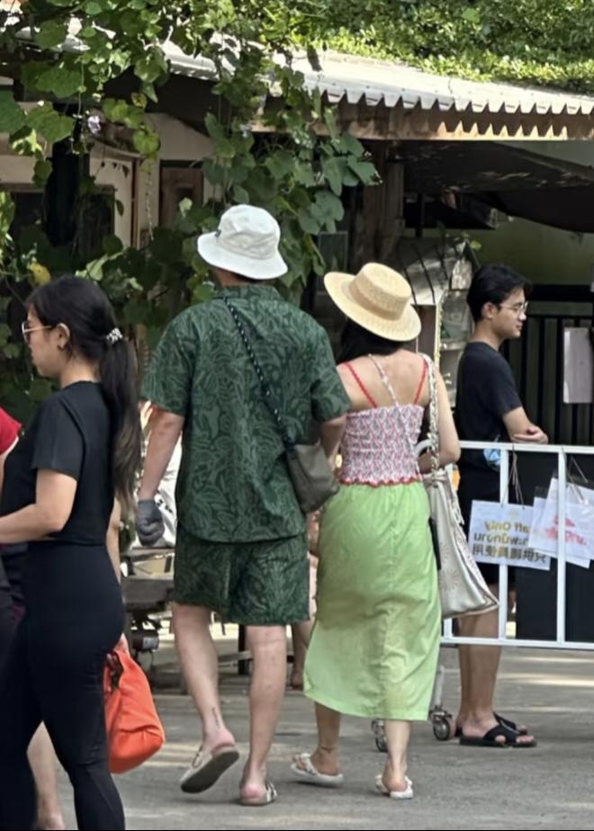 42岁雷佳音和老婆翟煦飞在泰国曼谷旅游，夫妻俩穿一身热带风衣服，在大白天牵着手逛