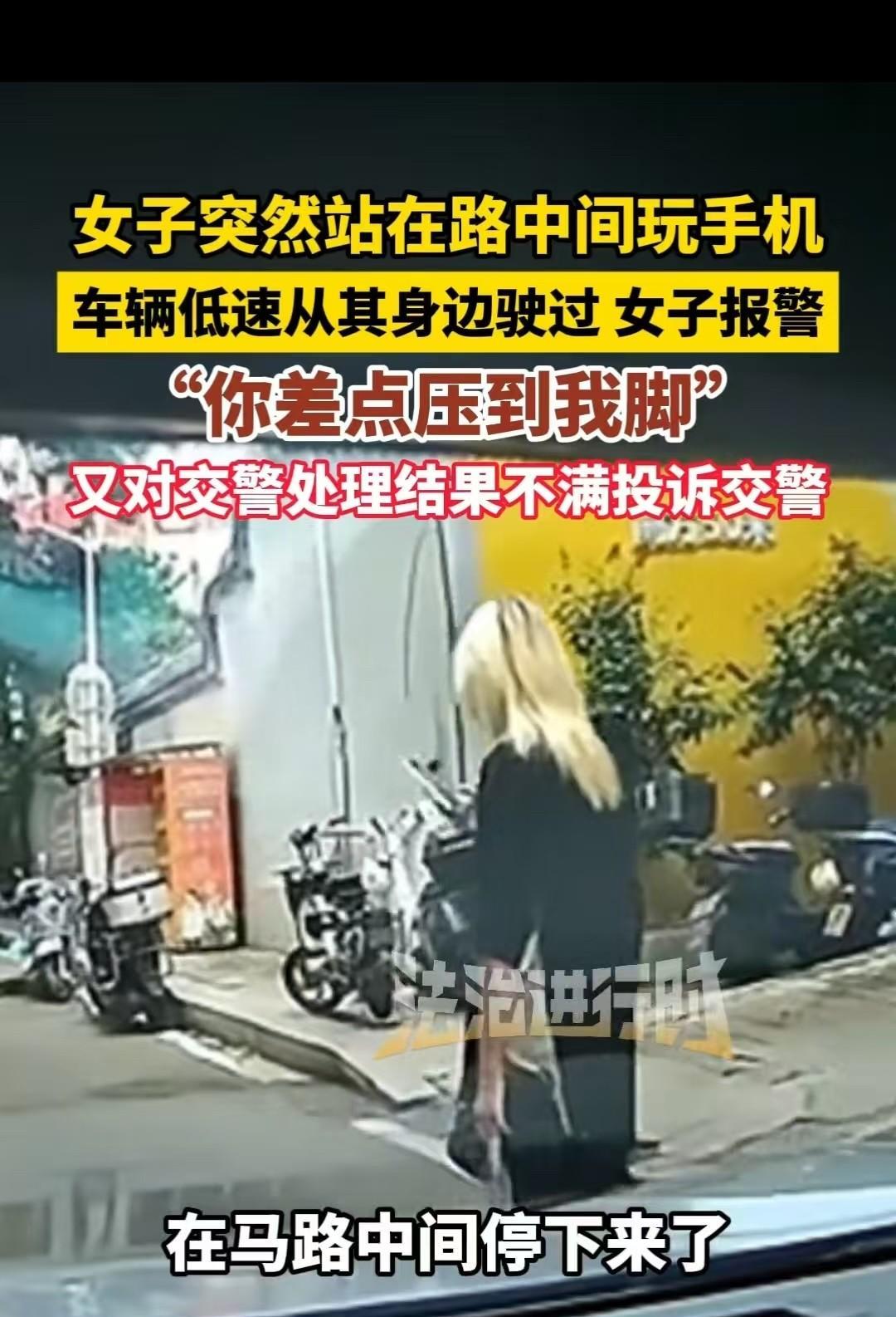福建，女子停在马路上玩手机，车主没有按喇叭，而是缓缓地从她身边开过去。女子觉得对