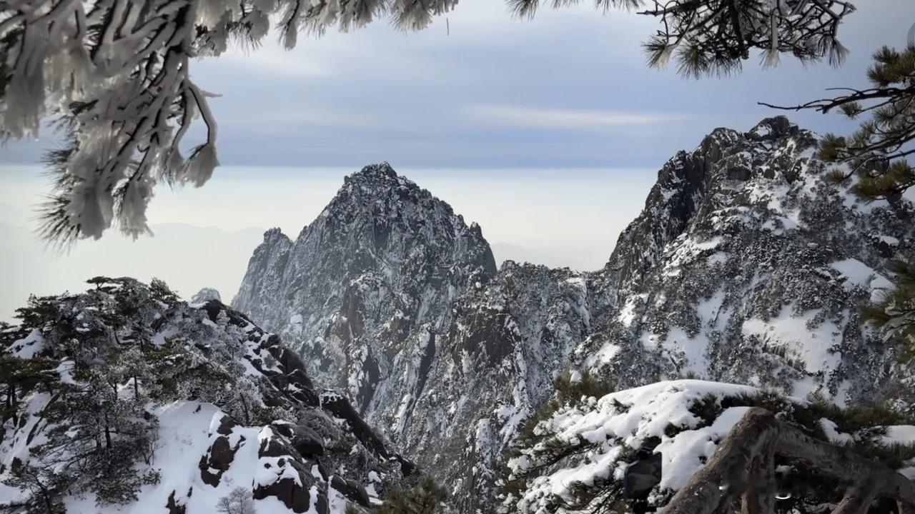 黄山前几天下雪，现在还有积雪。雪后的黄山美不胜收，像一幅山水画卷。山峰被雪覆盖