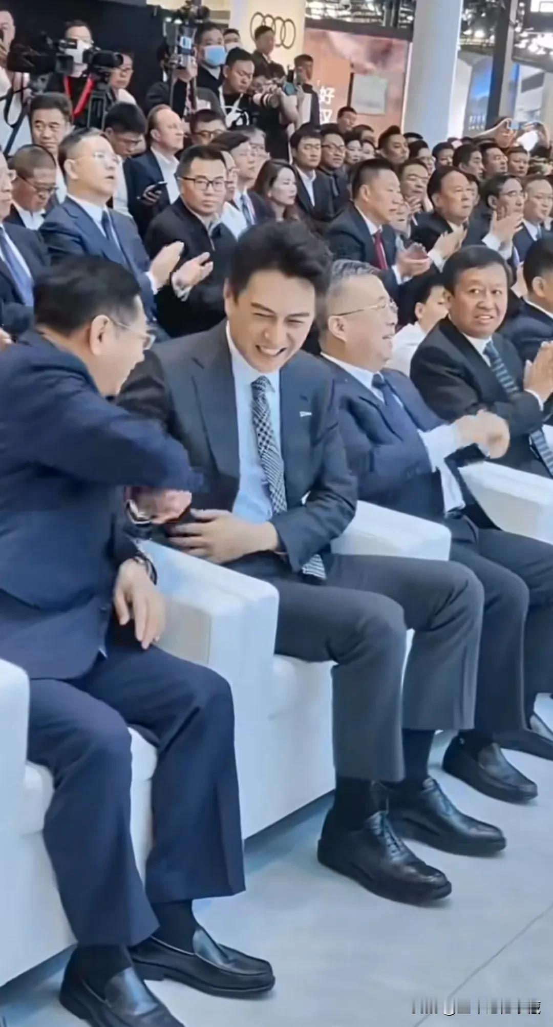 靳东身为红旗代言人亮相北京车展，靳东一身小西装外套，蓝色衬衫，格子领带，黑色正装
