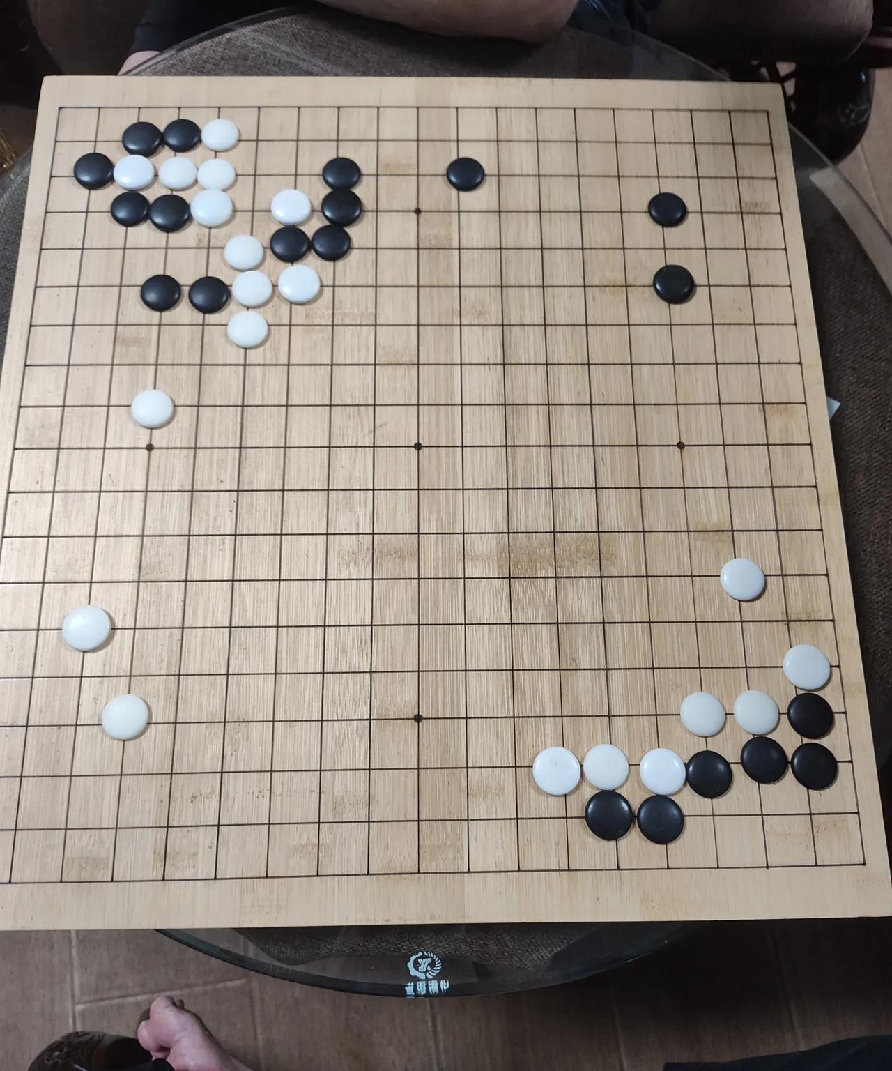 草根围棋对局。欢迎诊断。如图局面。黑白双方形势如何？黑棋应先破坏左下角白棋实地
