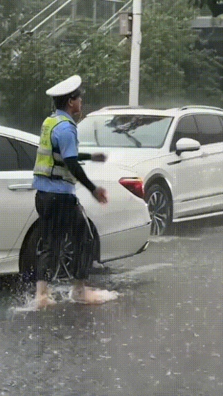 “这个交警火到人民日报了！”湖南益阳，一考点附近突降暴雨，未提前准备雨具，为保证