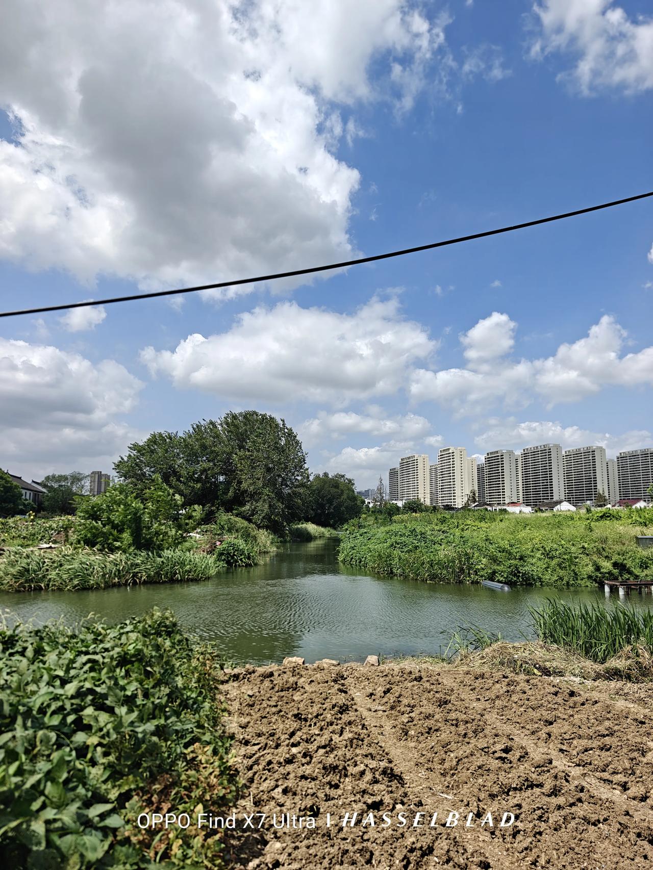 云低，云轻。云飘浮在河流之上的天空。天空轻蓝，绿水微波。清风，野草，野树，耕耘过